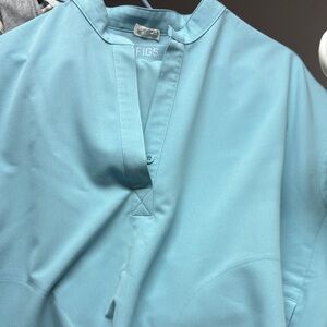 Figs women blue scrubs set shirt is small pant are medium petite.